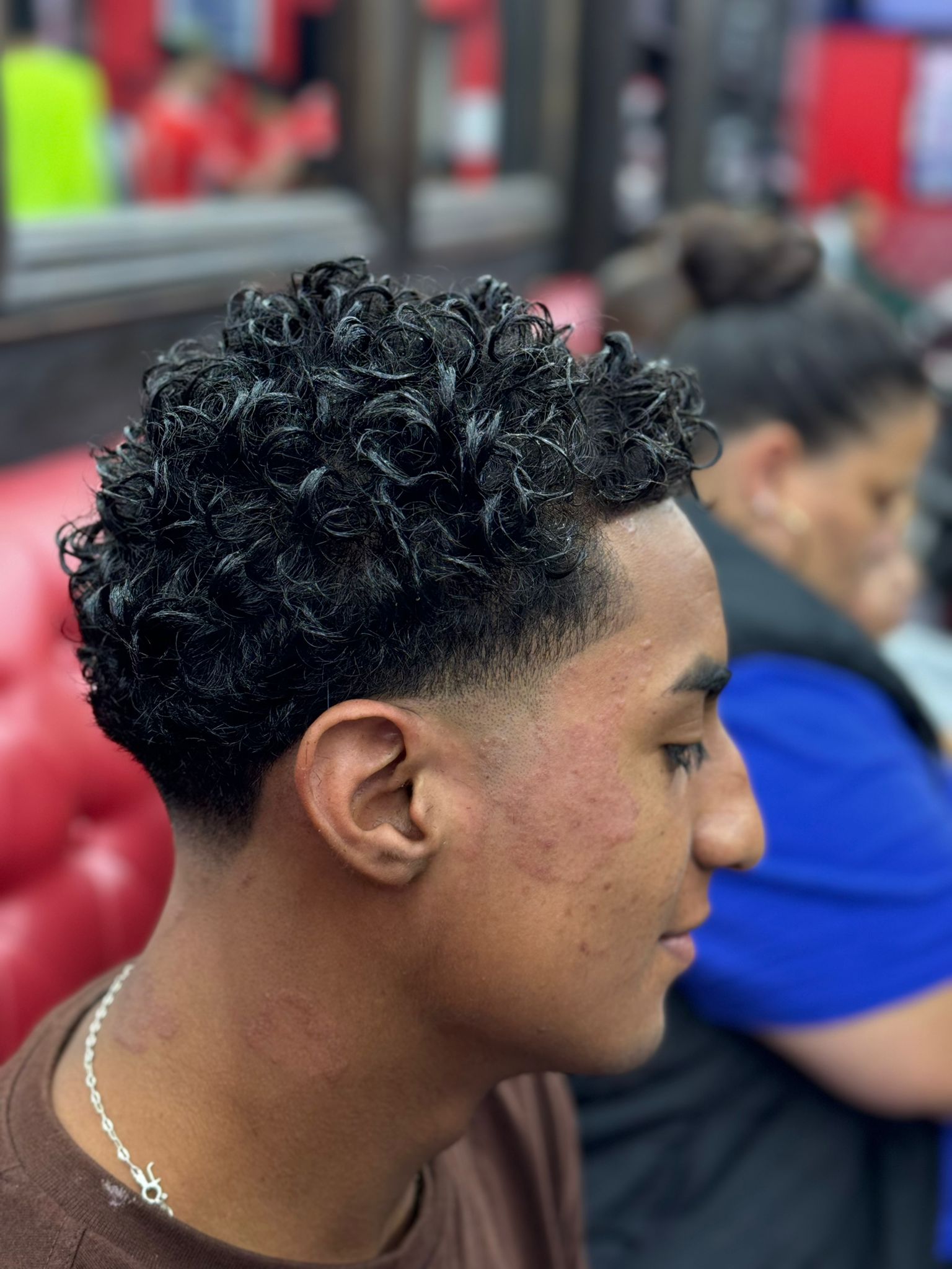Tight curls with skin fade — back view