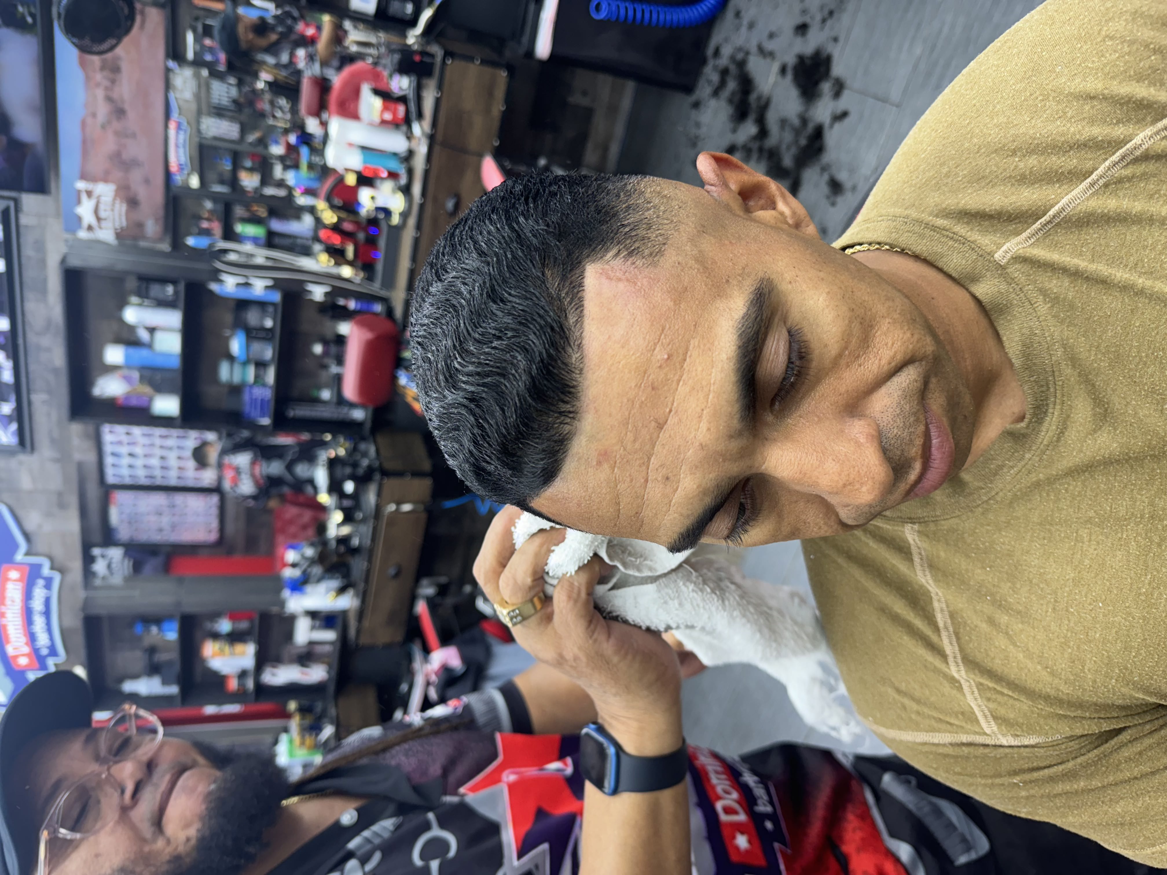 Adrian finishing a cut at Allstar Dominican Barbershop Marietta GA