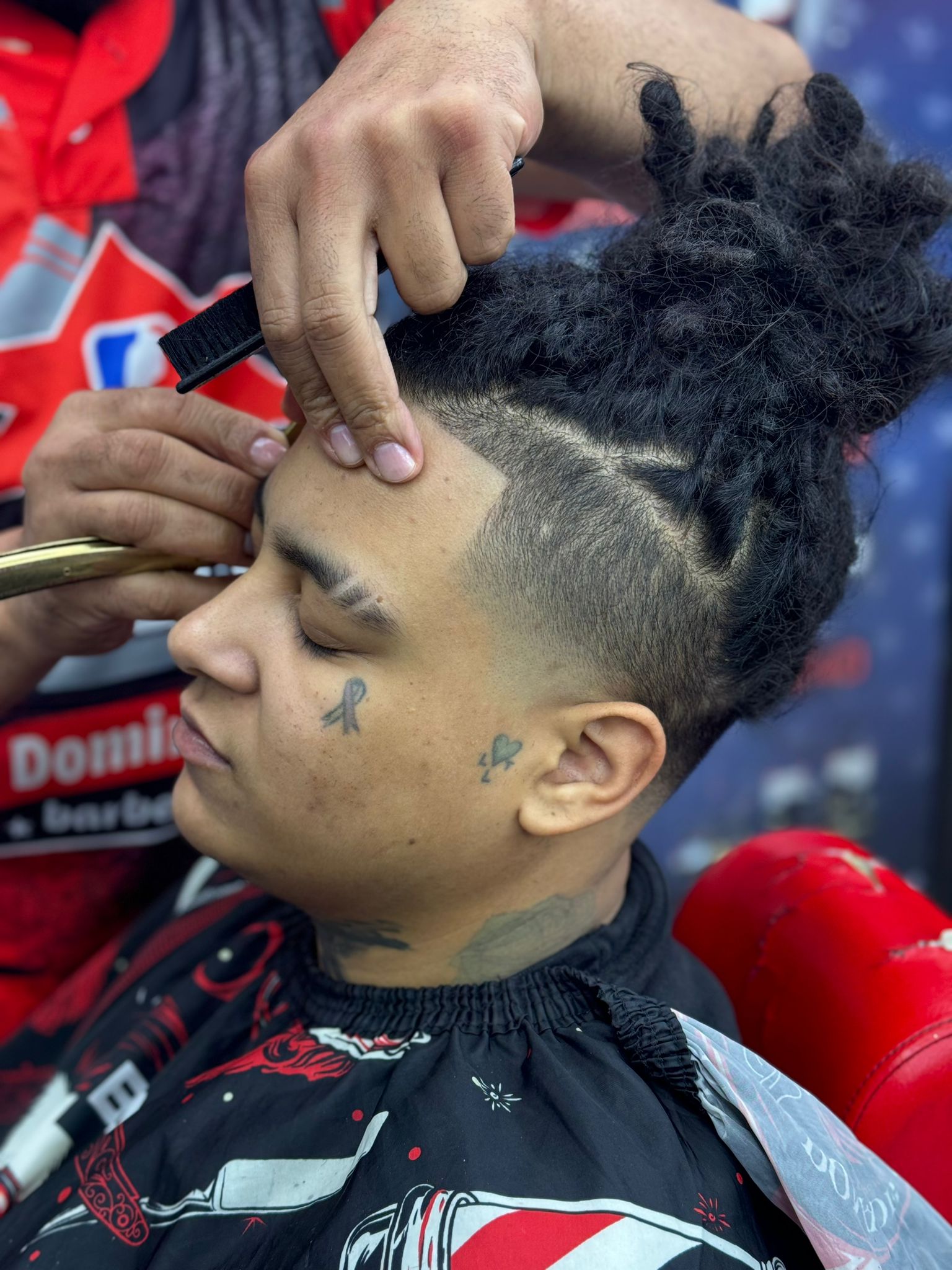 Barber at work at Allstar Dominican Barbershop Marietta GA